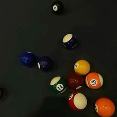 billiards and pool balls on a black table