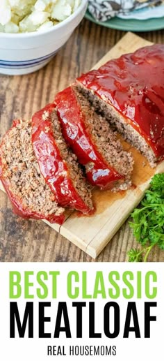 sliced meatloaf on a cutting board with sauce