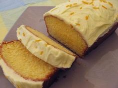 a piece of cake with white frosting on top and slices cut off from it