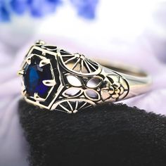 Get ready to fall in love with this breathtaking vintage piece! Crafted from genuine 925 sterling silver, this stunning ring features a mesmerizing simulated royal blue sapphire at its heart. The intricate filigree design adds a touch of timeless elegance, making it a must-have for any jewelry collection. And yes, it's stamped with 925 to assure you of its authenticity and quality. Don't miss out on owning this exquisite treasure! Silver Sapphire Ring Stamped 925 For Wedding, Vintage Sapphire Ring As A Gift, Vintage Sapphire Ring For Gift, Collectible Sterling Silver Engraved Ring With Intricate Design, Sterling Silver Engraved Ring With Intricate Design For Collectors, Sterling Silver Engraved Ring With Intricate Design, Silver Round Sapphire Collectible Ring, Silver Sapphire Collectible Ring, Sapphire Victorian Rings For Gift