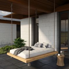 a white bed sitting on top of a wooden swing