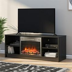 an entertainment center with a television and fire place