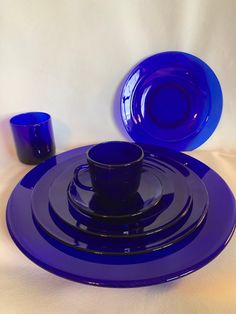 a blue plate and cup on a white table cloth