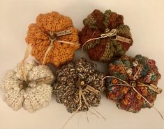 several crocheted pumpkins are tied together