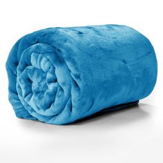 the blue blanket is rolled up and ready to be used