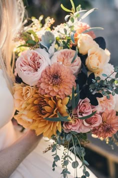 a woman holding a bouquet of flowers in her hand and the caption says, save