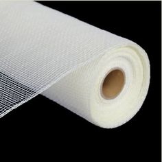 a roll of white mesh on a black background