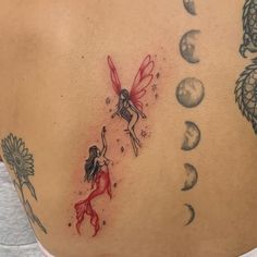 a woman's back with tattoos on her body and the moon, stars, and fairy tinkerbells