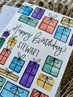 a birthday card with watercolor presents on it and the words, happy birthday stewart