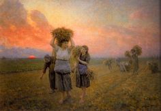 two women are walking through a field carrying hay