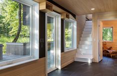 the inside of a house with stairs and windows