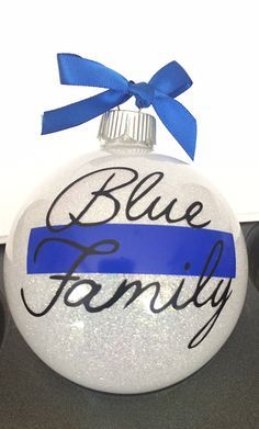 a blue family ornament with a ribbon on the front and back of it