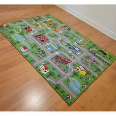 a child's play mat with cars and trucks on it in the middle of a wooden floor