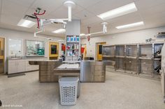 an empty laboratory with lots of cabinets and sinks