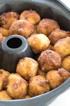 a pan filled with donuts sitting on top of a table