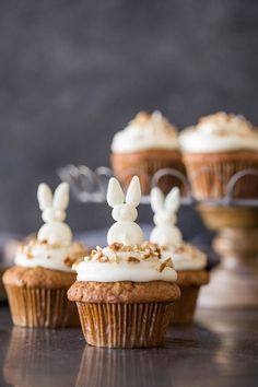 some cupcakes with frosting and bunny ears on them