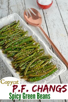 green beans with sesame seeds in a white serving dish