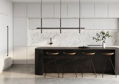 a kitchen with marble counter tops and bar stools