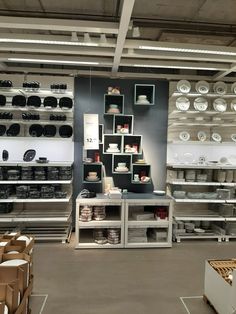 a room filled with lots of different types of plates and bowls on shelves next to each other