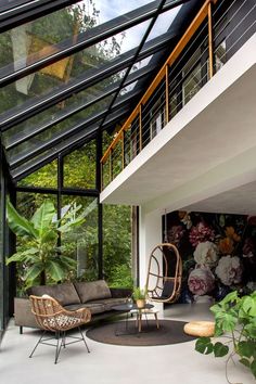 a living room filled with furniture under a glass roof