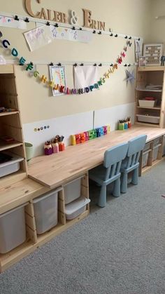 a child's playroom with toys and bookshelves on the wall, along with several storage bins