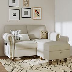 a living room filled with furniture and framed pictures on the wall above it's couch