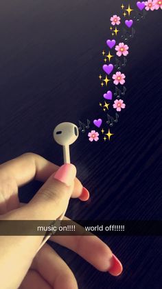 a hand holding a small white object with pink and purple flowers coming out of it