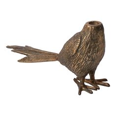 a bronze bird figurine sitting on top of a white background