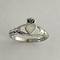 Sterling Silver Opal Heart Claddagh Ring. Heart Ring, White Opal Ring, Silver Ring, Irish Ring, Boho Ring, Friendship Ring, Can Be Worn Multiple Fingers, Midi Ring, Toe Ring. A Claddagh Ring Comprises Three Symbolic Elements, And Each Has Its Own Meaning A Crowned Heart Held By Two Hands - Symbolically, The Heart Represents Love, The Crown Denotes Loyalty, And The Hands Are A Sign Of Friendship Perfect Gift Idea For Any Occasion: Birthday, Anniversary, Engagement, Graduation, Bridesmaid, Mother’ Meaning Of Claddagh Ring, Claddaugh Engagement Rings, Irish Cladaggah Ring, Irish Friendship Ring, Irish Claddagh Wedding Rings, Cladaggah Ring, White Symbolic Promise Ring, Symbolic White Promise Ring, White Sterling Silver Heart Ring With Birthstone