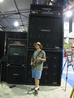 a man standing in front of some speakers