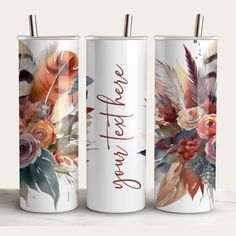 three personalized tumbles with flowers and feathers on the sides, one is white