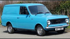 an old blue van is parked on the street