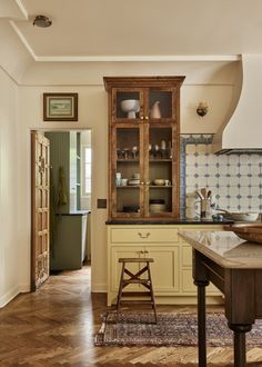 an old fashioned kitchen with wooden floors and cabinets