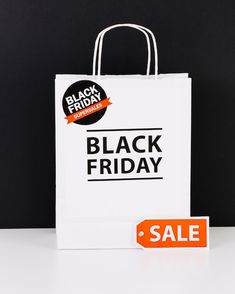 a black friday shopping bag with an orange sale tag