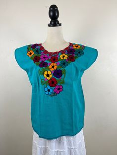 a woman's top with colorful flowers on it