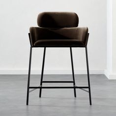 an image of a chair that is in the middle of a room with white walls