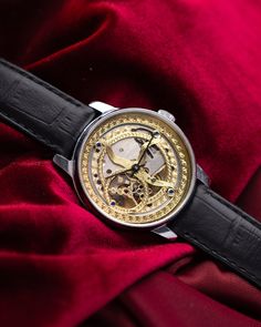 This customized Pobeda watch, with a 37 mm case, boasts a mesmerizing handcrafted skeleton dial that captures the beauty of celestial motifs. The intricate golden patterns etched into the dial evoke images of the cosmos, giving the timepiece an artistic and ethereal quality. The open-worked design of the dial not only enhances its aesthetic appeal but also provides a fascinating view of the inner mechanical workings, making it a true conversation piece. The watch's case is made from polished stainless steel, offering both durability and a sleek, modern look that contrasts beautifully with the ornate dial. This sturdy 37 mm case frames the celestial motif perfectly, ensuring that the dial remains the centerpiece of the design. Paired with a classic black leather strap, the watch exudes soph Luxury Classic Watch With Skeleton Dial, Gold Skeleton Dial Watch Accessories, Luxury Automatic Watch Accessories For Gift, Gold Watch Accessories With Skeleton Dial, Luxury Watches With Subdials For Gift, Luxury Automatic Watch As Gift, Gold Round Skeleton Dial Watch, Gold Round Watch With Skeleton Dial, Steampunk Automatic Watch For Formal Occasions