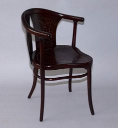 a wooden chair sitting on top of a white floor