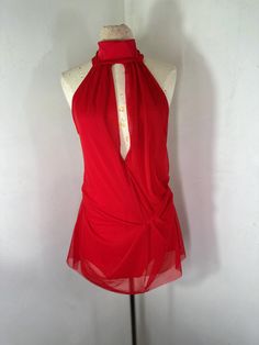 a mannequin wearing a red dress with a white collar