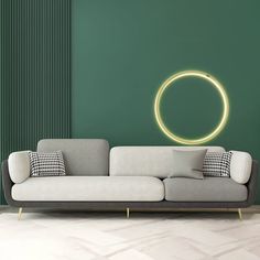 a couch in front of a green wall with a circular light on it's side