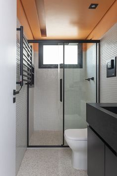 a bathroom with a toilet, sink and shower stall