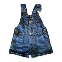 An exciting find for the vintage lover! These short overalls are in great shape, with a broken-in look and feel. The mid-wash blue denim is subtly printed with tiny red flowers with green leaves. The print is more faded in some areas. Buttons at the hips, snap chest pocket, back patch pockets. RUNS SMALL, more like a large 2T or small 3T. Made in U.S.A. 100% cotton Machine wash & dry Denim Shortalls In Medium Wash With Bib Front, Medium Wash Denim Shortalls With Bib Front, Vintage Denim Shortalls With Bib Front, Blue Denim Washed Shortalls, Vintage Denim Bib Front Shortalls, Blue Washed Denim Shortalls, Vintage Denim Blue Cotton Shortalls, Dark Wash Denim Bib Front Shortalls, Vintage Light Wash Denim Overalls