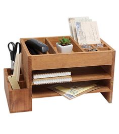 a wooden desk organizer with drawers and office supplies in it's centerpieces