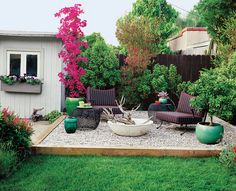 an outdoor patio area with chairs, tables and flowers on the grass in front of a shed