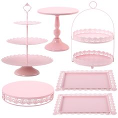 pink serving trays and cake stands with lace trim around the edges, on white background