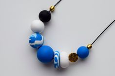 This handmade deep blue beaded necklace is made of unbreakable polymer clay beads. These beads are carefully made by hand, thus each of them can slightly differ in shape and smoothness. Each polymer clay necklace comes in a stylish packaging and makes a perfect gift. This modern necklace would be perfect for everyday wear or special occasion. You can easily dress in your own style with this blue necklace. Add some minimal, clean look to your outfit with this matte necklace. MORE DETAILS - Polyme Handmade Blue Polymer Clay Necklaces, Blue Beaded Polymer Clay Jewelry, Blue Polymer Clay Jewelry With Colorful Beads, Blue Wooden Beads Necklace As Gift, Blue Wooden Beads Necklace For Gift, Blue Necklaces With Wooden Beads For Gift, Handmade Bold Blue Jewelry, Bold Handmade Blue Jewelry, Bold Handmade Polymer Clay Jewelry