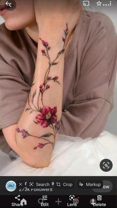 a woman with a flower tattoo on her arm