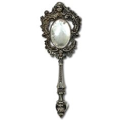 an ornate mirror is hanging on the wall with a key attached to it's side