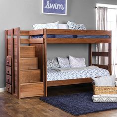 a bunk bed sitting on top of a hard wood floor next to a blue rug