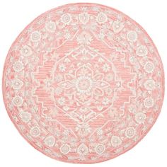 a round rug with an intricate design in pink and white on a white background,